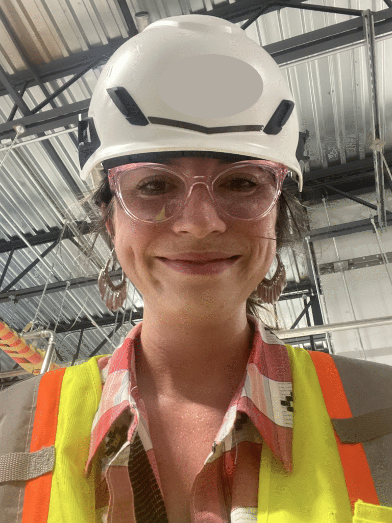 construction safety professional wearing hard hat, safety glasses, and safety vest